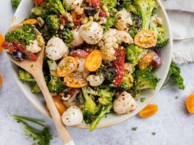 Broccoli cauliflower salad with mozzarella, tomatoes, black olives and roasted red peppers.