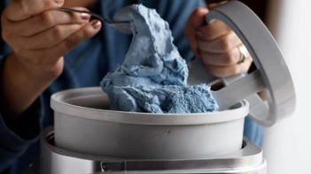 scooping up ice cream with scoop out of an ice cream maker