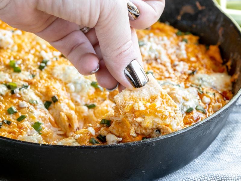 scooping up buffalo chicken dip with a cracker