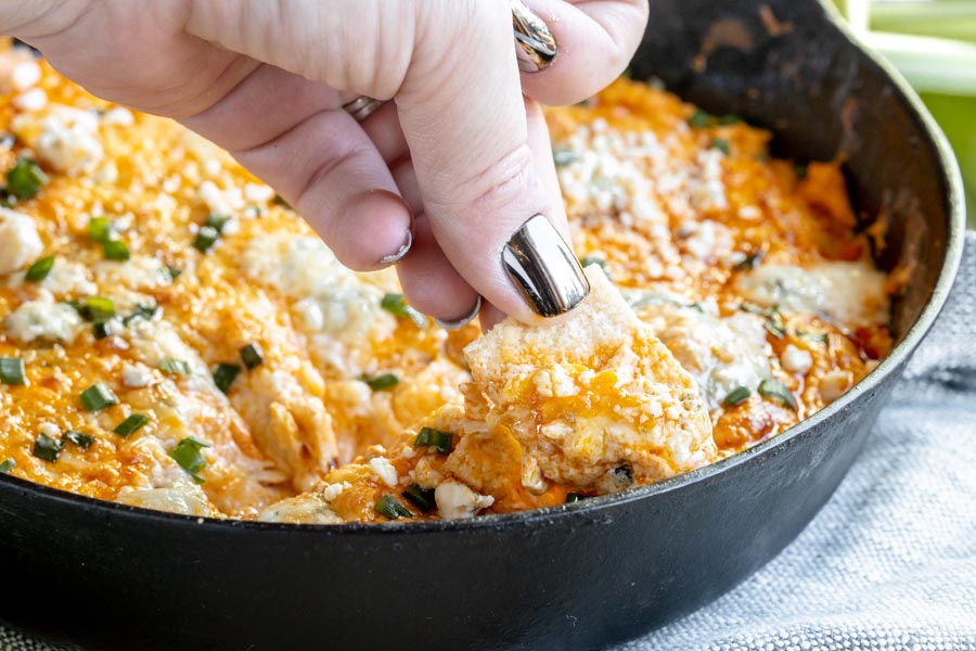 scooping up buffalo chicken dip with a cracker