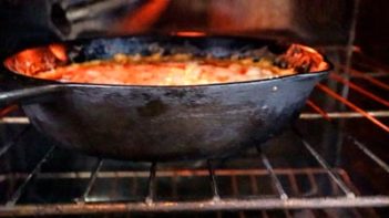 a cast iron skillet in the oven on the top rack