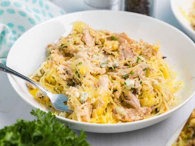A bowl of spaghetti squash mixed with buffalo chicken and blue cheese.