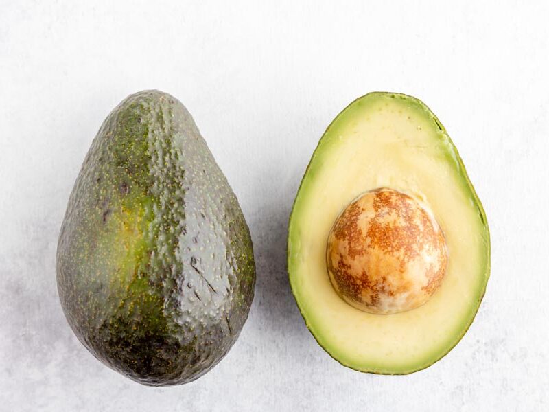 a whole avocado on the left, a half avocado on the right