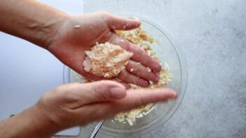 Hands shaping the canned chicken mixture into oval nuggets before cooking.
