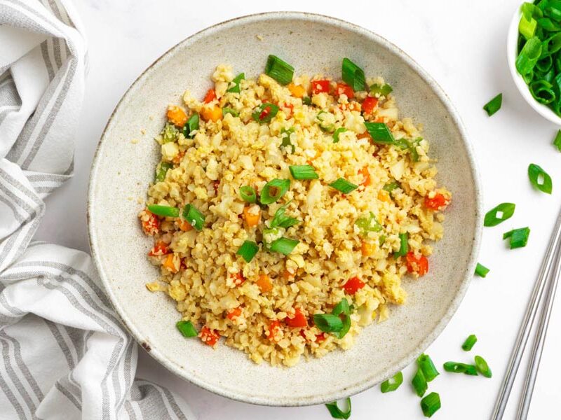 Keto cauliflower fried rice with carrots, bell pepper and green onions.