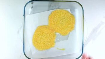 Two circles of melted cheese in a baking dish.