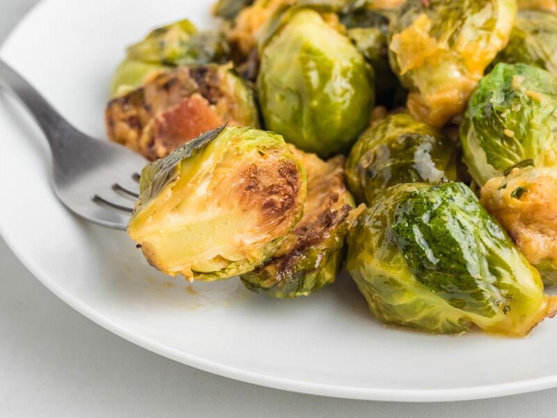 A fork holding a crispy brussels sprout.