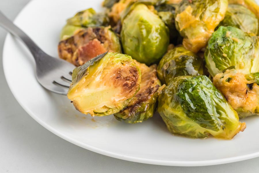 A fork holding a crispy brussels sprout.