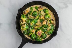Bright green brussels sprouts swimming in a creamy sauce.
