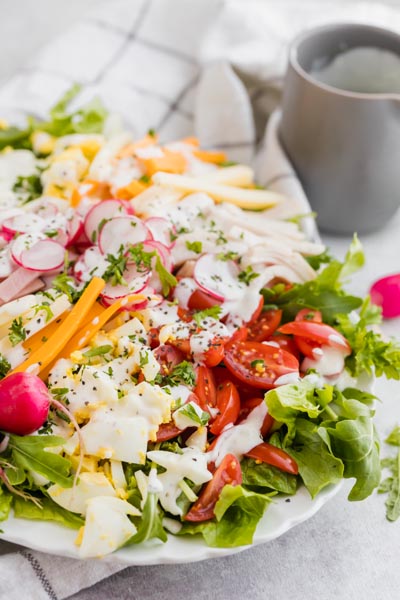 Crunchy chef salad topped with radish, egg, tomato, deli meat and creamy ranch dressing.