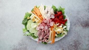 Assembled chef salad on a large white platter.