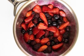 berries in a sauce pan cooking with the juices starting to release
