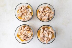 Diced cooked chicken layered on top of the cheese mixture in the lasagna bowls.