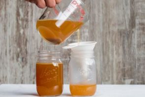 pouring chicken bone broth in mason jars