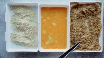 Three dishes. One with almond flour, the middle with beaten egg and the third with pork panko.