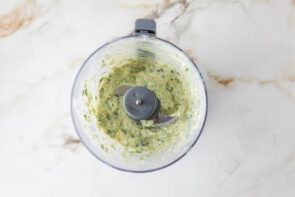 Creamy avocado herb dressing blended in a food processor for chicken cobb salad.