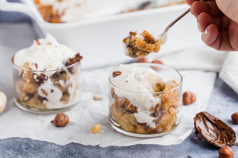 holding spoon of cake over a small dish of cake