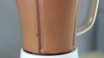 a blender mixing a chocolate smoothie inside