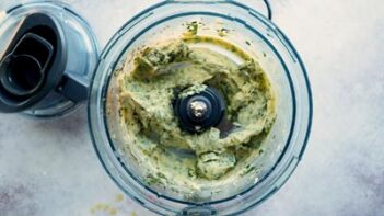 A food processor with creamy cilantro aioli inside.