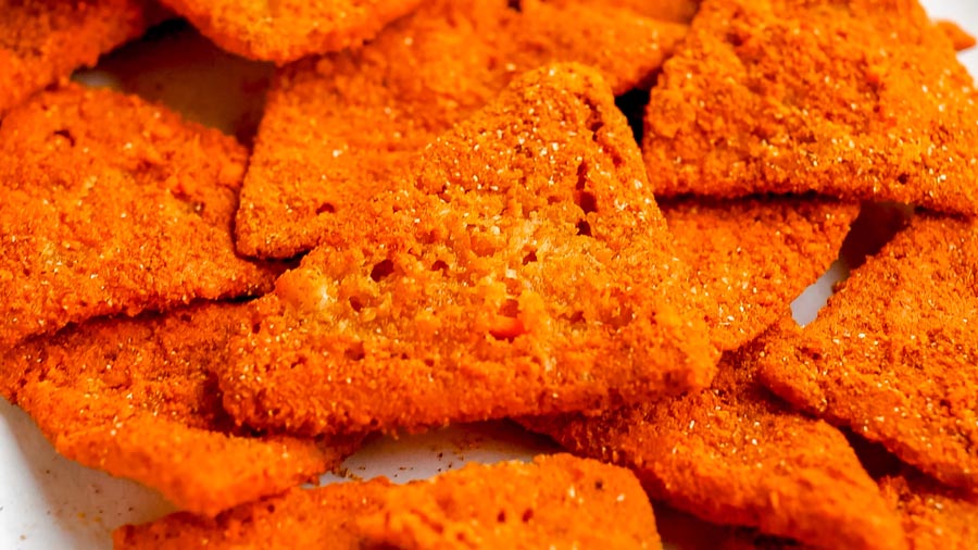 Extreme close-up highlighting the bubbly, airy texture of baked cottage cheese chips.