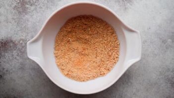 A bowl of blended cottage cheese mixed with seasoning to form a thick, spreadable mixture.