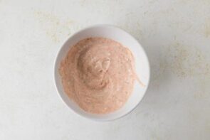 A bowl with blended cottage cheese mixed with marinara sauce.