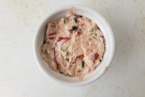 Blended cottage cheese and sauce mixed with pizza toppings in a ramekin.