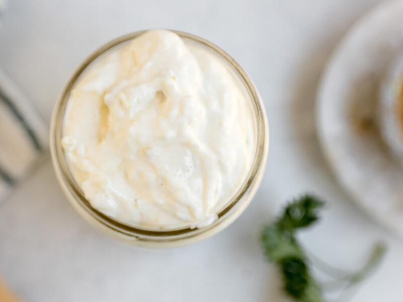 Overhead close-up of thick and creamy keto cream of chicken soup in a glass jar.