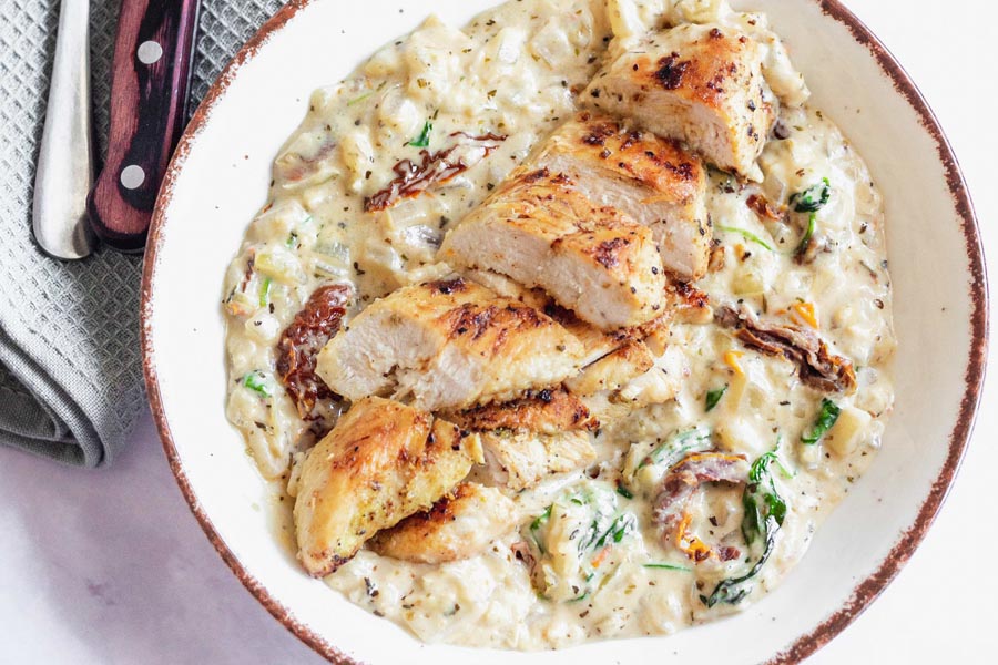 a plate of tuscan chicken with low carb white sauce