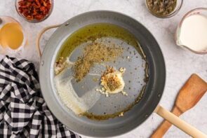 Butter and seasonings melting in a skillet.