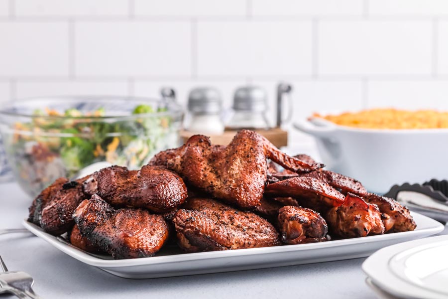 a platter with wings for dinner served with salad and cauliflower gratin