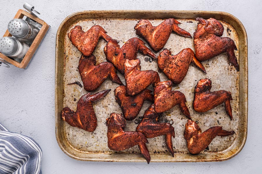 a bunch of smoked wings on a baking tray