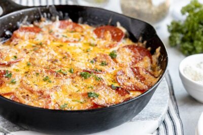 skillet cooked in a cast iron skillet topped with pepperoni and parsley