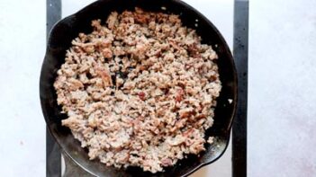 ground sausage cooked in a black cast iron skillet