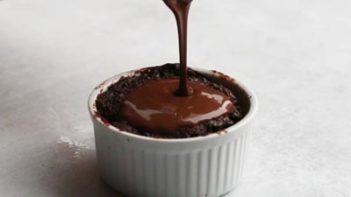 Drizzling keto chocolate sauce on the lava cake