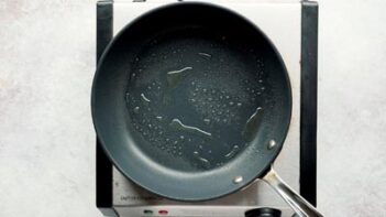 A non-stick skillet with cooking spray inside.