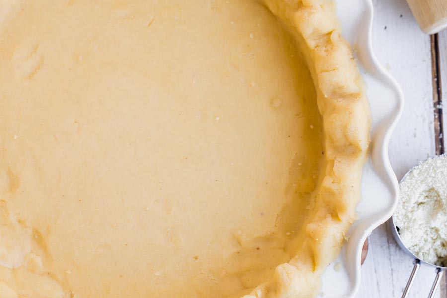 overhead view of roll out pie crust in a plate