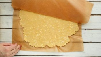 flatten pie crust covered with a brown parchment paper