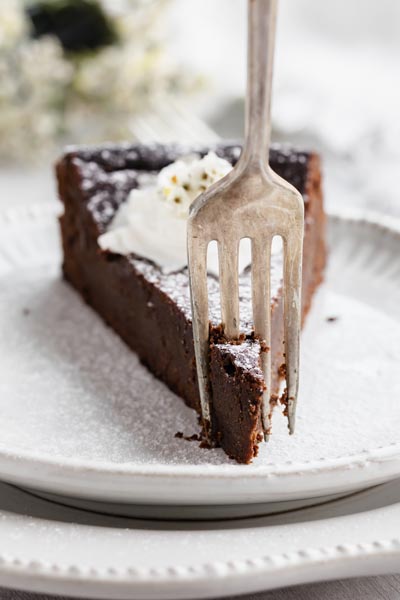 a fork going through a slice of cake