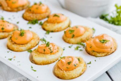 a tray of fried deviled eggs filled with a smoky roasted pepper filling