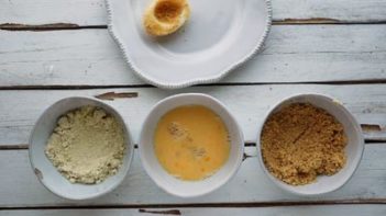 three bowls with almond flour, egg and pork panko in them