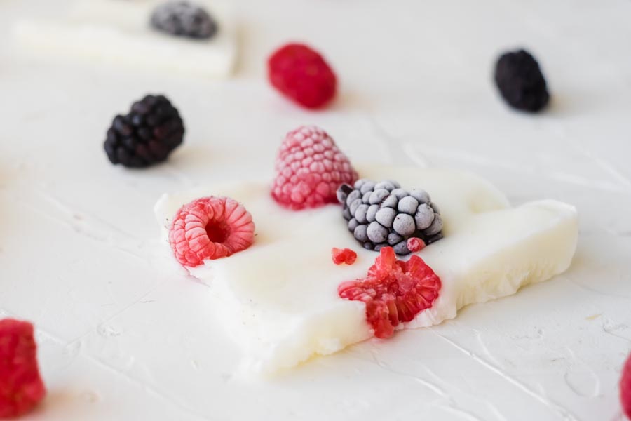 a large bark of yogurt with frozen blackberries