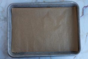 a sheet of parchment paper on a small baking tray