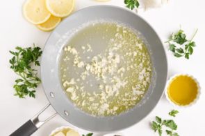 a skillet with garlic and melted butter