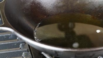 avocado oil heating up in a skillet