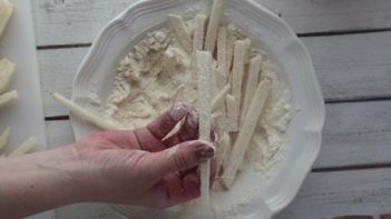jicama fries getting coated in a protein powder batter