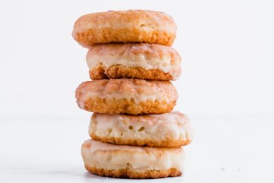 a large stack of glazed keto donuts