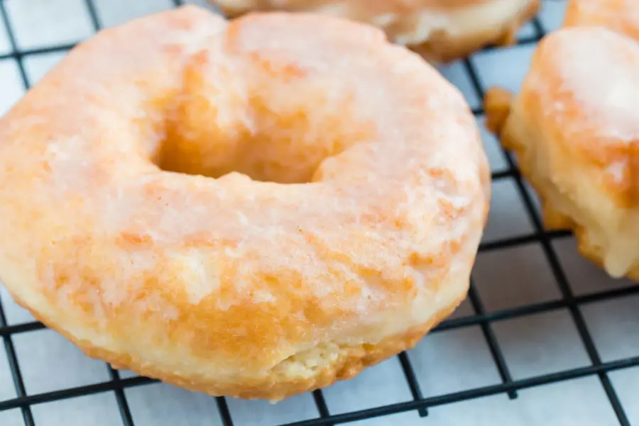 glazed covered doughnut on a wire rack