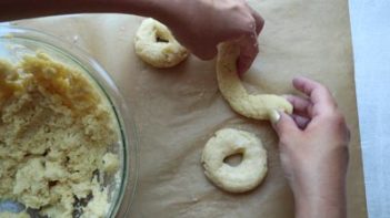 forming donut shapes on a piece of parchment paper