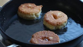 donuts frying in a skillet